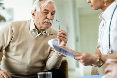 Nurse checking on an elderly patient at home